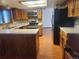 Bright kitchen with tiled backsplash, stainless steel appliances, wooden cabinets, and laminate flooring at 812 S Ouray St, Aurora, CO 80017
