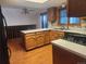 Open kitchen layout with laminate flooring, wooden cabinets and dining area at 812 S Ouray St, Aurora, CO 80017