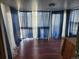 View of living room featuring laminate flooring and large blue curtains at 812 S Ouray St, Aurora, CO 80017