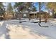 House with expansive backyard, snowy ground, and mature trees at 14059 W 5Th Ave, Golden, CO 80401