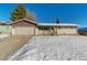 Ranch-style home with attached garage and snowy front yard at 14059 W 5Th Ave, Golden, CO 80401