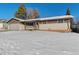 Brick ranch home with a snow-covered lawn at 14059 W 5Th Ave, Golden, CO 80401