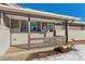 Covered front porch with railing and brick facade at 14059 W 5Th Ave, Golden, CO 80401