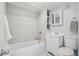 Clean bathroom with a bathtub, vanity, and tiled walls at 3500 N Marion St, Denver, CO 80205