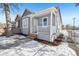 Charming bungalow with gray siding, white porch, and well-maintained landscaping at 3500 N Marion St, Denver, CO 80205