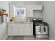 White cabinets, granite counters, and gas range in kitchen at 3500 N Marion St, Denver, CO 80205