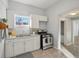 Updated kitchen featuring white shaker cabinets and gas stove at 3500 N Marion St, Denver, CO 80205