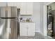 White shaker cabinets and stainless steel refrigerator in kitchen at 3500 N Marion St, Denver, CO 80205