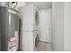 Laundry room with washer, dryer, and hot water heater at 3500 N Marion St, Denver, CO 80205