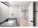 Modern bathroom featuring a sleek vanity, undermount sink, stone countertop, and modern lighting at 8080 E Dartmouth Ave # 26, Denver, CO 80231