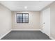 Bright bedroom with neutral walls, white trim, carpet flooring, and a window with security bars at 8080 E Dartmouth Ave # 26, Denver, CO 80231