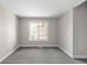 Bright bedroom with neutral walls, white trim, carpet flooring, and a window offering ample natural light at 8080 E Dartmouth Ave # 26, Denver, CO 80231