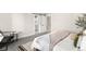 Bedroom view with adjacent bathroom, stylish decor, and natural lighting at 8080 E Dartmouth Ave # 26, Denver, CO 80231