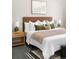 Cozy bedroom showcasing a beautifully appointed bed with stylish headboard, complemented by neutral tones and tasteful decor at 8080 E Dartmouth Ave # 26, Denver, CO 80231