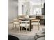 Open-concept dining area with modern table, chairs, and views into the kitchen at 8080 E Dartmouth Ave # 26, Denver, CO 80231