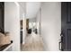Inviting foyer with light wood floors, a bench, and view into the open living space at 8080 E Dartmouth Ave # 26, Denver, CO 80231