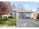 Charming single-story home with a well-manicured lawn, lush landscaping, and attached two-car garage at 8080 E Dartmouth Ave # 26, Denver, CO 80231