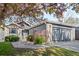 Charming single-story home with lush landscaping, a well-manicured lawn, and an attached two-car garage at 8080 E Dartmouth Ave # 26, Denver, CO 80231