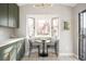 Cozy kitchen nook with bay window offering natural light and view of the front yard at 8080 E Dartmouth Ave # 26, Denver, CO 80231