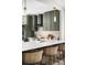 Close-up of kitchen island with sink, modern olive cabinets, and sleek stainless appliances at 8080 E Dartmouth Ave # 26, Denver, CO 80231
