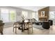 Stylish living room area with round dining table, modern fireplace, and large windows at 8080 E Dartmouth Ave # 26, Denver, CO 80231