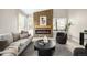 Contemporary living room with wood paneling, fireplace, large windows, and stylish modern decor at 8080 E Dartmouth Ave # 26, Denver, CO 80231