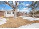 Large backyard with mature trees and patchy snow cover at 12008 W Mexico Pl, Lakewood, CO 80228