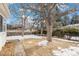 Large backyard with mature trees and snow patches at 12008 W Mexico Pl, Lakewood, CO 80228