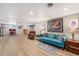 Finished basement with teal couch and hardwood floors at 12008 W Mexico Pl, Lakewood, CO 80228