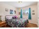 Bedroom with hardwood floors and a window offering natural light at 12008 W Mexico Pl, Lakewood, CO 80228