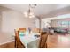 Dining area with wood table, four chairs, and view into the kitchen at 12008 W Mexico Pl, Lakewood, CO 80228