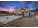 Brick ranch house with attached garage and driveway, snow-covered yard at 12008 W Mexico Pl, Lakewood, CO 80228