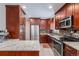 Modern kitchen featuring stainless steel appliances and granite countertops at 12008 W Mexico Pl, Lakewood, CO 80228