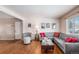 Hardwood floor living room with gray sectional sofa and entryway view at 12008 W Mexico Pl, Lakewood, CO 80228