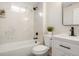 Updated bathroom with white vanity, marble shower/tub, and modern fixtures at 11083 Northglenn Dr, Northglenn, CO 80233