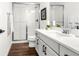 Stylish bathroom featuring a glass-enclosed shower and a white vanity with modern fixtures at 174 Rockingham Cir, Castle Pines, CO 80108