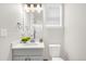 This bathroom features a window, gray vanity with quartz countertop, and sleek fixtures and hardware at 174 Rockingham Cir, Castle Pines, CO 80108