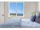 This bedroom features a scenic backyard view, and a comfortable bed with blue accents at 174 Rockingham Cir, Castle Pines, CO 80108