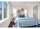 This bedroom features a large window, decorative baskets, and a comfortable bed with blue accents at 174 Rockingham Cir, Castle Pines, CO 80108