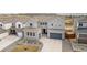 Beautiful two-story home with a gray exterior, well-maintained landscaping, and a two-car garage at 174 Rockingham Cir, Castle Pines, CO 80108