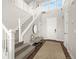 The entryway features a staircase, bench, round mirror and entry closet to the right of the front door at 174 Rockingham Cir, Castle Pines, CO 80108