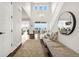 Bright foyer featuring a two-story ceiling, hardwood floors, and a staircase leading to the upper level at 174 Rockingham Cir, Castle Pines, CO 80108