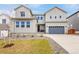 A two-story home with a two car garage, long driveway, and grass yard at 174 Rockingham Cir, Castle Pines, CO 80108