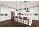 Modern kitchen featuring a large island with seating, stainless steel appliances, and white cabinetry at 174 Rockingham Cir, Castle Pines, CO 80108