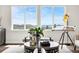 Cozy corner of the living room with scenic outdoor views from two wide windows and stylish decor at 174 Rockingham Cir, Castle Pines, CO 80108