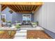 Relaxing covered patio with comfortable seating and views of the landscaped backyard at 174 Rockingham Cir, Castle Pines, CO 80108