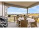 Covered patio with table, chairs, barbecue, and scenic views at 174 Rockingham Cir, Castle Pines, CO 80108