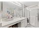 Well-lit bathroom featuring a large mirror, white cabinets, and a glass-enclosed shower for a clean and modern feel at 5426 Bobcat St, Frederick, CO 80504