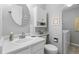 Clean bathroom with a white vanity, sink, toilet, and convenient laundry area at 5426 Bobcat St, Frederick, CO 80504