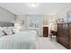 Serene bedroom featuring a plush bed, side tables with lamps, and ample natural light at 5426 Bobcat St, Frederick, CO 80504